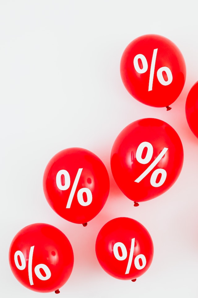 Red Balloons With Percentage Symbols on White Background